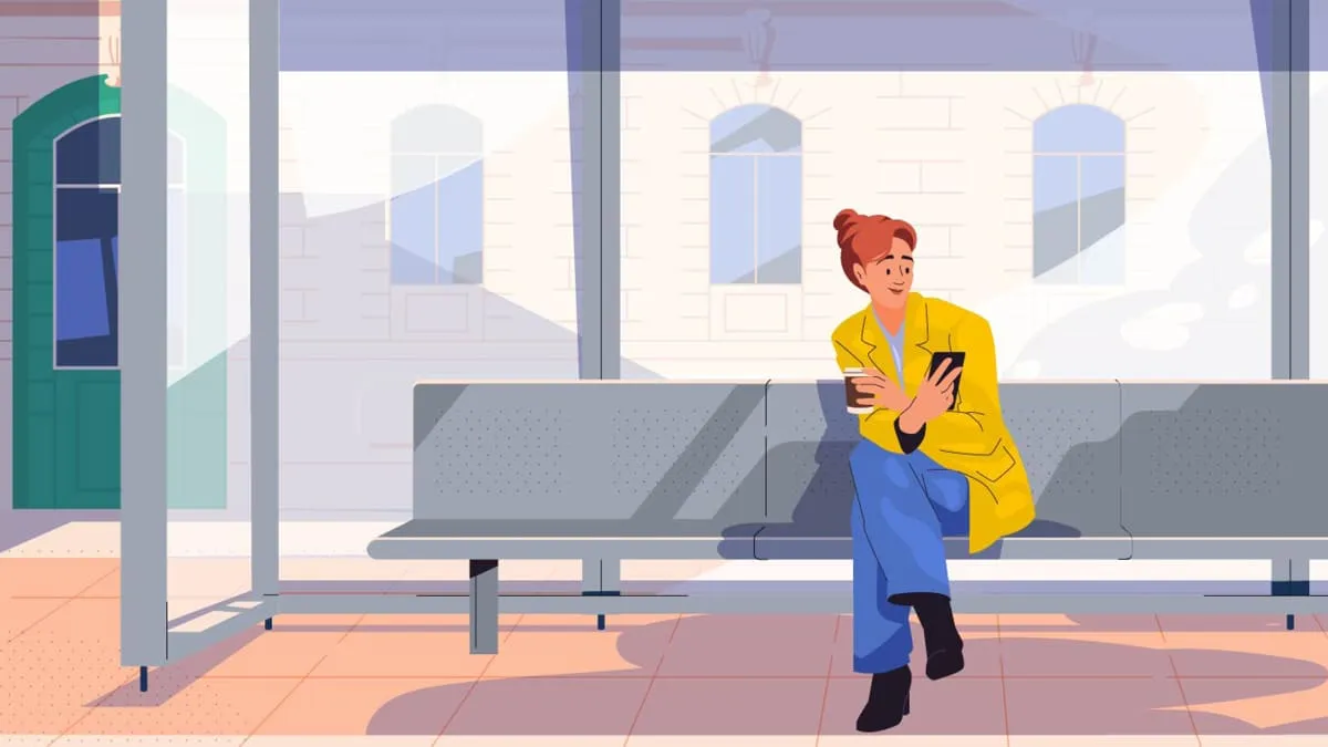 Illustrated woman in a yellow coat sits at a tram stop holding a coffee cup and her phone.
