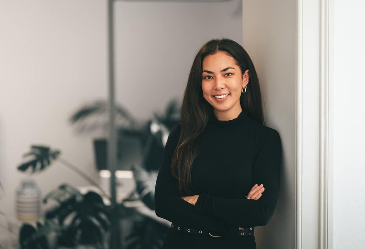 Smiling colleague with folded arms in the office
